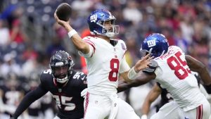 New York Giants quarterback Daniel Jones throws a pass under pressure from Houston Texans defensive end Derek Barnett in the first half of a preseason NFL football game, Saturday, Aug. 17, 2024, in Houston. (Eric Gay/AP)