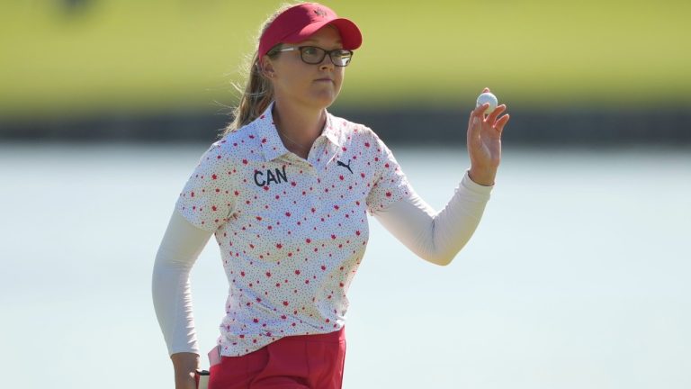 Brooke Henderson, of Canada, acknowledges the crowd after putting on the 18th green during the final round of the women's golf event at the 2024 Summer Olympics, Saturday, Aug. 10, 2024, at Le Golf National, in Saint-Quentin-en-Yvelines, France. (Matt York/AP)