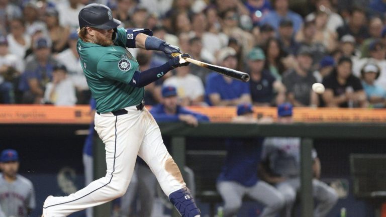 Seattle Mariners' Justin Turner follows through on an RBI single off a pitch by New York Mets pitcher Phil Maton during the seventh inning of a baseball game, Saturday, Aug. 10, 2024, in Seattle. (Jason Redmond/AP Photo)
