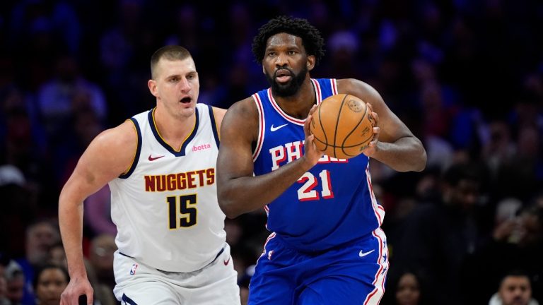 Philadelphia 76ers centre Joel Embiid, right, tries to keep away from Denver Nuggets centre Nikola Jokic. (Matt Slocum/AP)