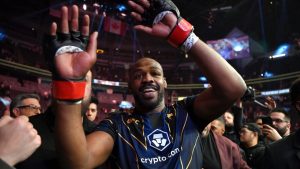 Jon Jones celebrates his victory over Ciryl Gane as he walks from the Octagon after UFC 285. (David Becker/AP)