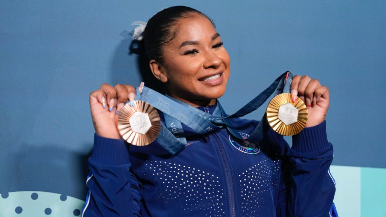 Jordan Chiles, of the United States, holds up her medals after the women's artistic gymnastics individual apparatus finals at the 2024 Summer Olympics, Monday, Aug. 5, 2024, in Paris, France. (Charlie Riedel/AP)