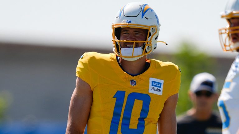 Los Angeles Chargers quarterback Justin Herbert smiles next to centre Bradley Bozeman during training camp, July 29, 2024. (AP/Ryan Sun)