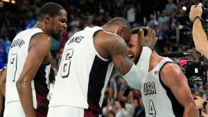 United States' Kevin Durant, LeBron James and Steph Curry celebrate after beating Serbia during a men's semifinals basketball game at Bercy Arena at the 2024 Summer Olympics, Thursday, Aug. 8, 2024, in Paris, France. (Mark J. Terrill/AP Photo)