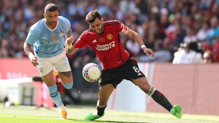 Manchester United's Bruno Fernandes, right, is tackled by Manchester City's Kyle Walker during the English FA Cup final soccer match between Manchester City and Manchester United at Wembley Stadium in London, Saturday, May 25, 2024. (AP/Ian Walton)