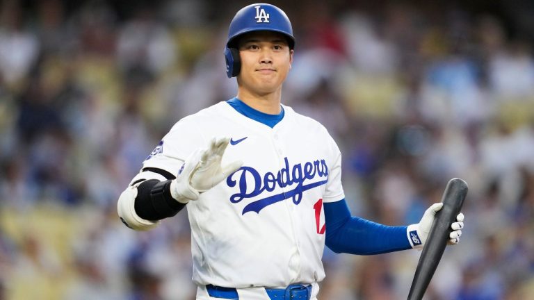 Los Angeles Dodgers designated hitter Shohei Ohtani greets the Tampa Bay Rays dugout during the first inning of a baseball game in Los Angeles, Friday, Aug. 23, 2024. (Ashley Landis/AP Photo)