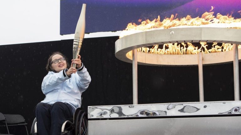 British Paralympian Helene Raynsford holds the Paralympic Torch during the flame lighting ceremony in Stoke Mandeville, widely considered the birthplace of the Paralympic Games, England, Saturday, Aug. 24, 2024. (Thomas Krych/AP Photo)
