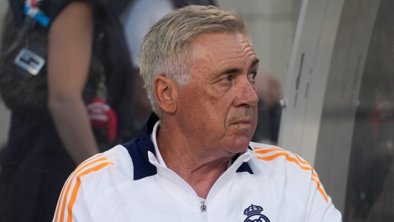 Real Madrid coach Carlo Ancelotti sits on the bench before a friendly against AC Milan, July 31, 2024. (AP Photo/Erin Hooley)