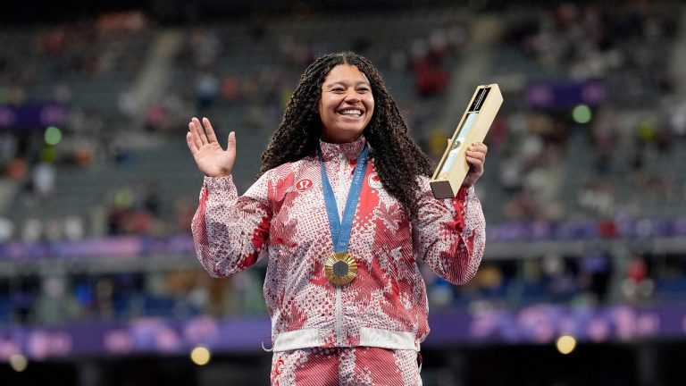 Canada's Camryn Rogers celebrates her gold medal won in the women's hammer throw event on the podium at the Summer Olympics in Paris, Tuesday, Aug. 6, 2024. (Adrian Wyld/CP)