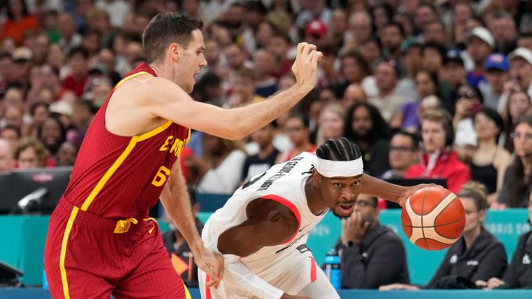 Shai Gilgeous-Alexander, of Canada, drives on Xabi Lopez-Arostegui, of Spain, in a men's basketball game at the 2024 Summer Olympics, Friday, Aug. 2, 2024, in Villeneuve-d'Ascq, France. (Mark J. Terrill/AP Photo)