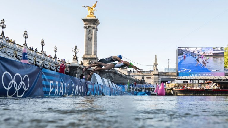 Athletes jump into the water to compete in the swimming race in the Seine River, during the mixed relay triathlon, at the 2024 Olympic Games, in Paris, France, Monday, Aug. 5, 2024. (Martin Bureau/Pool Photo via AP)