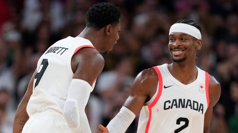 RJ Barrett celebrates with Shai Gilgeous-Alexander, of Canada, after a three-point basket in the final minute of the a men's basketball game against Spain at the 2024 Summer Olympics, Friday, Aug. 2, 2024, in Villeneuve-d'Ascq, France. (Mark J. Terrill/AP Photo)