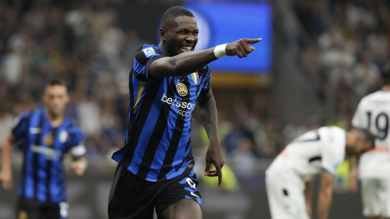 Inter Milan's Marcus Thuram celebrates scoring his side's 3rd goal during the Serie A soccer match between Inter Milan and Atalanta at the at the San Siro stadium in Milan, Italy, Friday, Aug. 30, 2024. (Luca Bruno/AP Photo)
