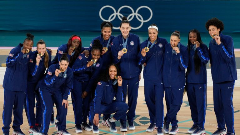 The United States team poses for a picture with their gold medals at Bercy Arena at the 2024 Summer Olympics, Sunday, Aug. 11, 2024, in Paris, France. (AP/Michael Conroy)