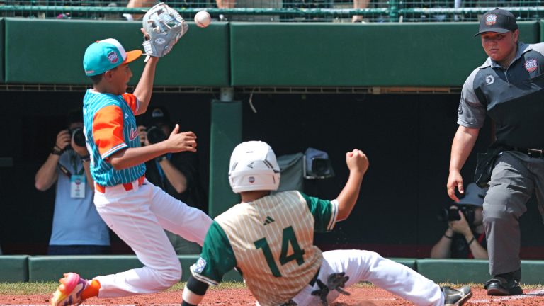 Venezuela's Jose Perez, left, gets the late throw from Venezuela's catcher Jesus Diaz as Taiwan's Chiu Wei-Che (14) scores on a wild pitch during the third inning of the International Championship baseball game at the Little League World Series tournament in South Williamsport, Pa., Saturday, Aug. 24, 2024. (Gene J. Puskar/AP)