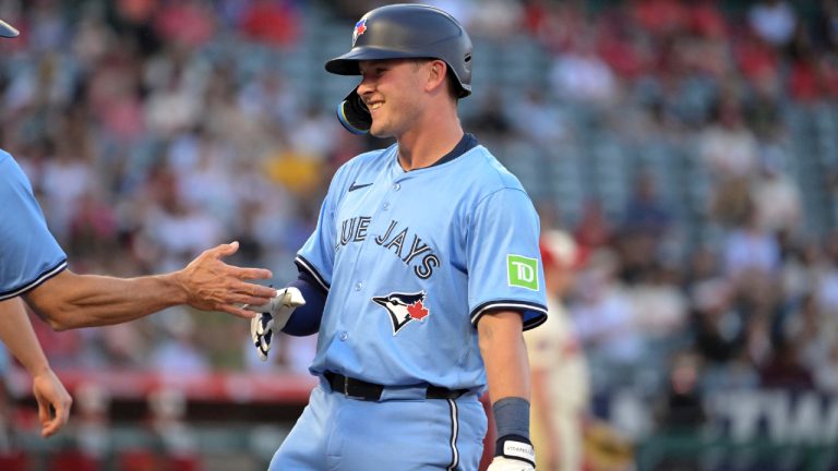 Toronto Blue Jays' Will Wagner, right reacts at first base after hitting an RBI single during the third inning of a baseball game against the Los Angeles Angels, Monday, Aug. 12, 2024, in Anaheim, Calif. (Jayne-Kamin-Oncea/AP)