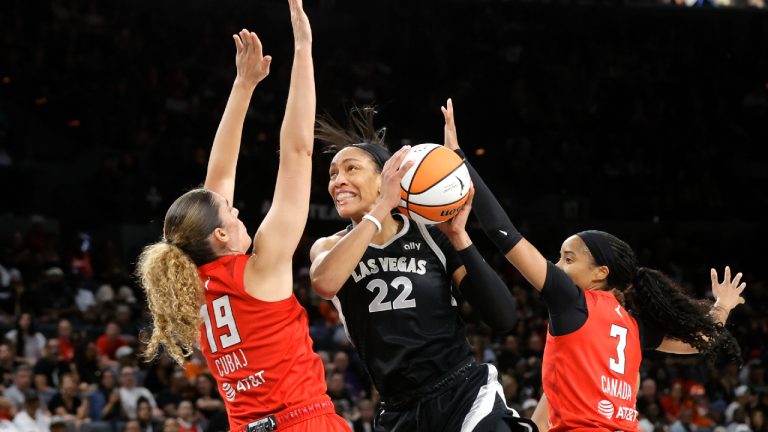 Las Vegas Aces center A'ja Wilson (22) prepares to shoot between Atlanta Dream forward Lorela Cubaj (19) and guard Jordin Canada (3) during the first half of an WNBA basketball game Friday, Aug. 30, 2024 in Las Vegas. (Steve Marcus/Las Vegas Sun via AP)