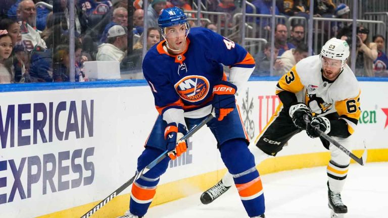 New York Islanders' Robert Bortuzzo (41) looks to pass the puck away from Pittsburgh Penguins' Radim Zohorna (63) during the first period of an NHL hockey game. (Frank Franklin II/AP)