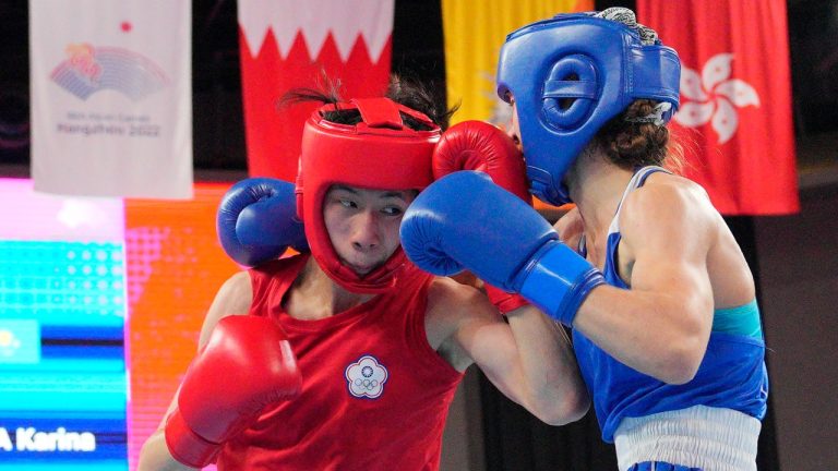 Taiwan's Lin Yu Ting, left, competes with Kazakhstan's Karina Ibragimova during the women's 54-57Kg boxing final at the 19th Asian Games in Hangzhou, China, Thursday, Oct. 5, 2023. (Vincent Thian/AP Photo)