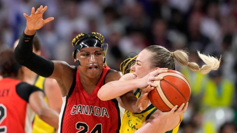 Canada's Aaliyah Edwards, left, reaches in on Australia's Tess Madgen during a women's basketball game at the 2024 Summer Olympics, Thursday, Aug. 1, 2024, in Villeneuve-d'Ascq, France. (Michael Conroy/AP Photo)