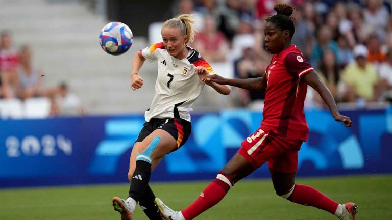 Germany's Lea Schueller fights for the ball with Canada's Kadeisha Buchanan during a women's quarterfinal soccer match between Canada and Germany at the 2024 Summer Olympics. (Daniel Cole/AP)