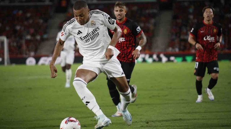 Real Madrid's Kylian Mbappe runs with the ball during a Spanish La Liga soccer match between Mallorca and Real Madrid at the Son Moix Stadium in Palma de Mallorca, Spain, Sunday, Aug. 18, 2024. (Francisco Ubilla/AP)