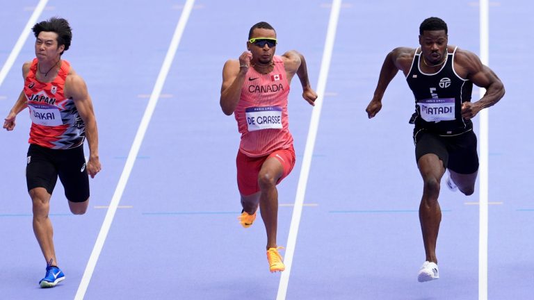 Andre De Grasse, of Canada, crosses the finish line to qualify in a men's 100 meters round 1 heat at the 2024 Summer Olympics, Saturday, Aug. 3, 2024, in Saint-Denis, France. (Martin Meissner/AP Photo)