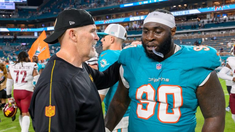 Washington Commanders head coach Dan Quinn talks with Miami Dolphins defensive tackle Neville Gallimore (90) on the field after an NFL pre-season football game, Saturday, Aug. 17, 2024, in Miami Gardens, Fla. (Doug Murray/AP Photo)