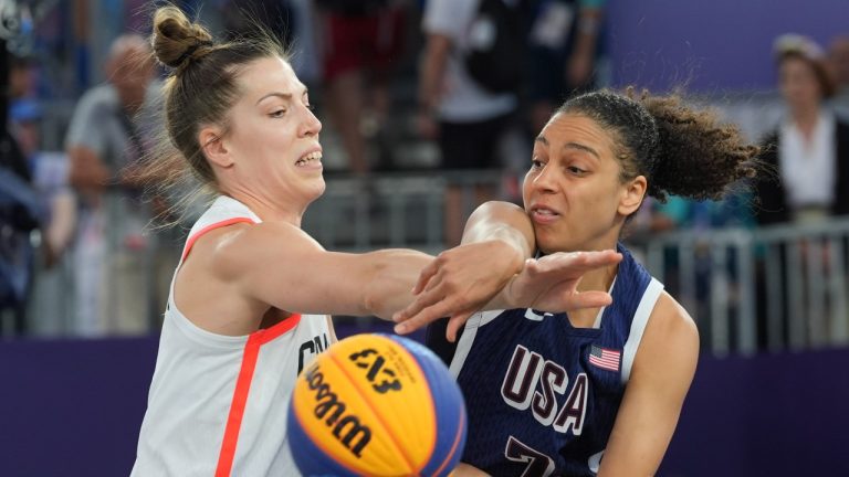 Canada's Michelle Plouffe (left) and United States Cierra Burdick (7) battle for the ball during the women's 3 X 3 basketball bronze medal game at the Summer Olympics in Paris on Monday, Aug.5, 2024. (Adrian Wyld/THE CANADIAN PRESS)