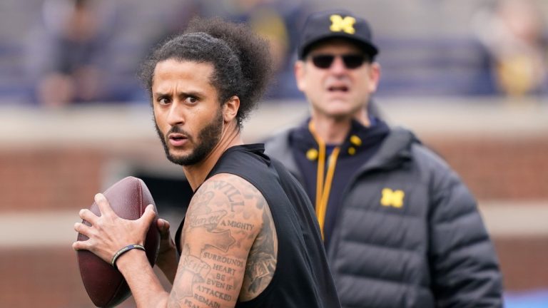 Michigan head football coach Jim Harbaugh watches as former NFL quarterback Colin Kaepernick throws during halftime of an NCAA college football intra-squad spring game, Saturday, April 2, 2022, in Ann Arbor, Mich. (Carlos Osorio/AP)