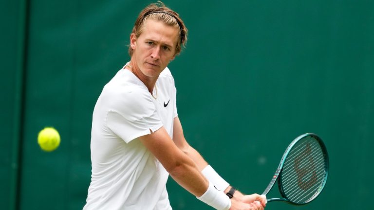 Sebastian Korda of the United States plays a backhand return to Giovanni Mpetshi Perricard of France during their first round match at the Wimbledon tennis championships in London, Tuesday, July 2, 2024. (Mosa'ab Elshamy/AP)