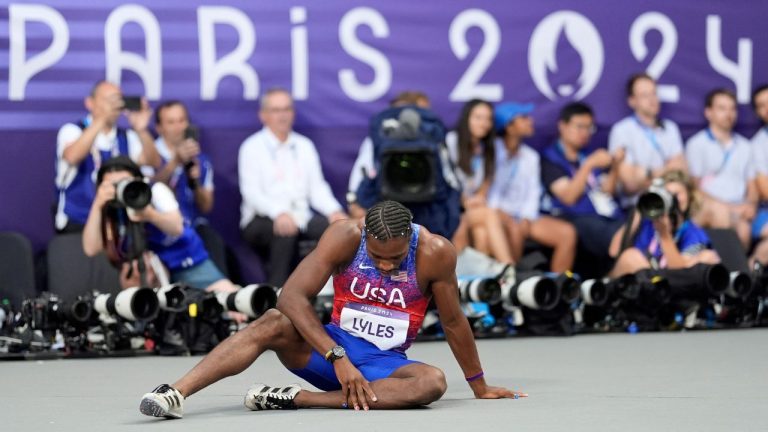 Noah Lyles, of the United States, pauses on the track after the men's 200-meter final at the 2024 Summer Olympics, Thursday, Aug. 8, 2024, in Saint-Denis, France. (Matthias Schrader/AP Photo)