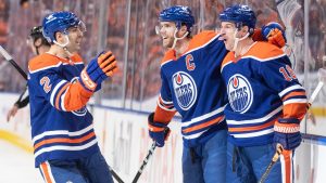 Edmonton Oilers' Evan Bouchard (2), Connor McDavid (97) and Zach Hyman (18) celebrate a goal against the Los Angeles Kings during second period NHL playoff action in Edmonton on Wednesday April 24, 2024. (Jason Franson/CP)