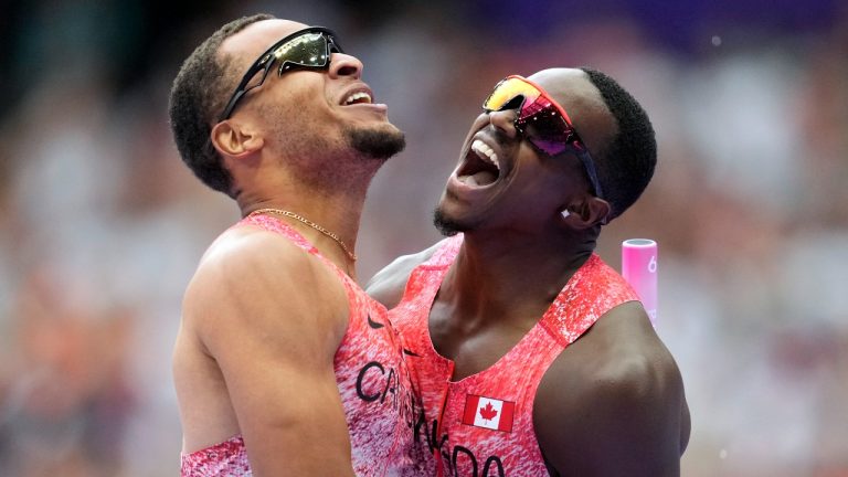 Aaron Brown, right, and Andre de Grasse, of Canada, celebrate after winning the gold medal in the men's 4 x 100 meters relay final at the 2024 Summer Olympics, Friday, Aug. 9, 2024, in Saint-Denis, France. (Ashley Landis/AP Photo)