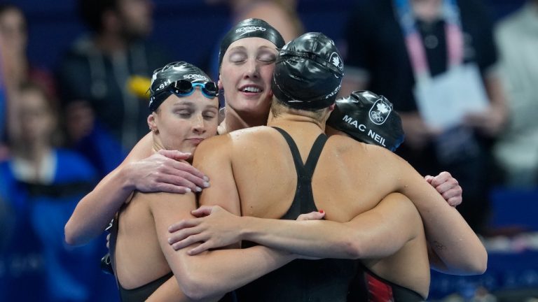 Canada teammates Summer McIntosh, left to right, Taylor Ruck, Penny Oleksiak and Maggie Mac Neil hug after competing in the women's 4 x 100-meter freestyle relay final at the 2024 Summer Olympics, Saturday, July 27, 2024, in Nanterre, France. (Adrian Wyld/THE CANADIAN PRESS)