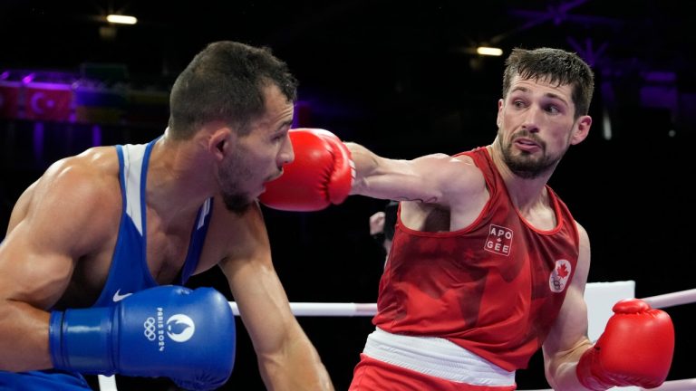 Canada's Wyatt Sanford hits Bulgaria's Radoslav Rosenov in their men's 63.5 kg preliminary boxing match at the 2024 Summer Olympics, Monday, July 29, 2024, in Paris, France. (Ariana Cubillos/AP Photo)