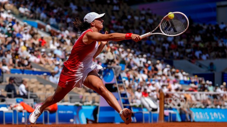 Iga Swiatek of Poland returns the ball against Qinwen Zheng of China during their women's semifinals match at the Roland Garros stadium, at the 2024 Summer Olympics, Thursday, Aug. 1, 2024, in Paris, France. (Manu Fernandez/AP Photo)