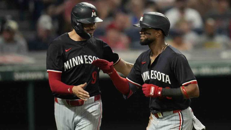 Minnesota Twins' Trevor Larnach, left, congratulates Willi Castro, on his home run in the eighth inning of a baseball game against the Cleveland Guardians, Tuesday, Sept. 17, 2024, in Cleveland. (Sue Ogrocki/AP)