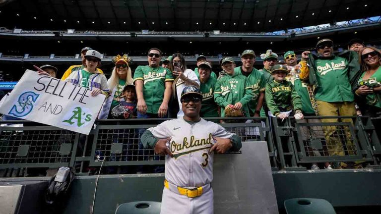 Oakland Athletics third base coach Eric Martins (3) poses with fans before a baseball game against the Seattle Mariners, Sunday, Sept. 29, 2024, in Seattle. (Lindsey Wasson/AP)