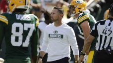 Warm day at Lambeau Field causes Packers centre to vomit on football