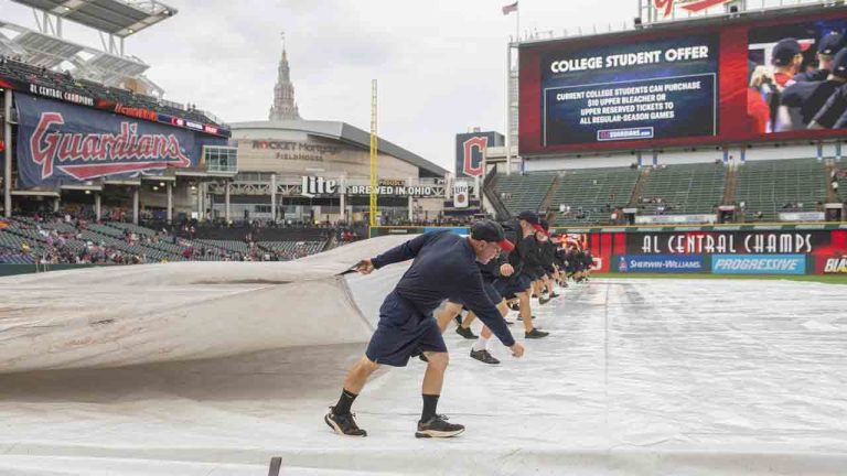 Cleveland Guardians grounds crew remove the tarp from the infield before a baseball game between the Guardians and the Houston Astros in Cleveland, Sunday, Sept. 29, 2024. (Phil Long/AP)