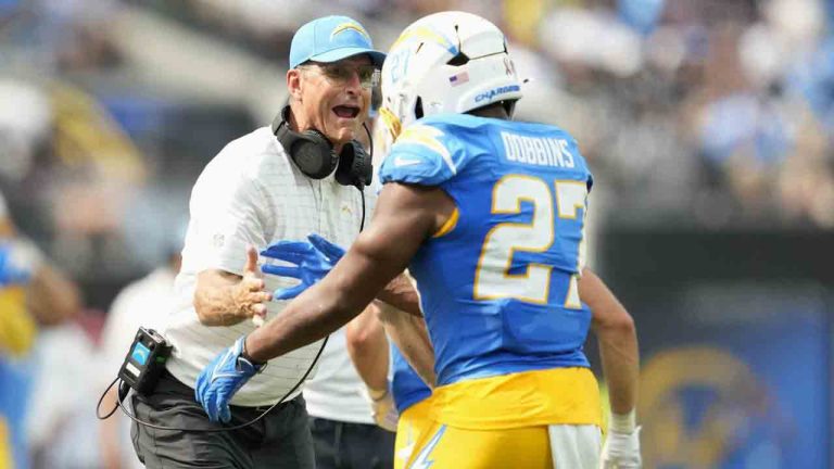 Los Angeles Chargers running back J.K. Dobbins (27) is congratulated by head coach Jim Harbaugh after scoring against the Las Vegas Raiders during the second half of an NFL football game, Sunday, Sept. 8, 2024, in Inglewood, Calif. (Ashley Landis/AP)