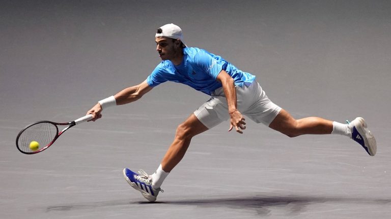 Argentina's Francisco Cerundolo plays a shot against Great Britain's Jack Draper during the Davis Cup group stage finals match at the AO Arena, Manchester, Friday Sept. 13, 2024. (Martin Rickett/PA via AP)