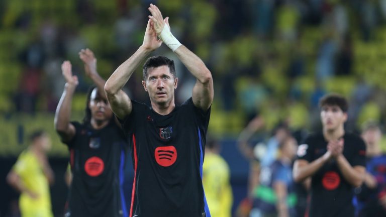 Barcelona's Robert Lewandowski, front, celebrates at the end of a Spanish La Liga soccer match against Villarreal at the La Cerámica stadium in Villarreal, Spain, Sunday, Sept. 22, 2024. Barcelona won the game 5-1.(AP Photo/Alberto Saiz)