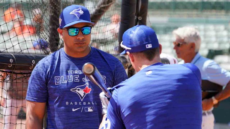 Toronto Blue Jays hitting coach Guillermo Martinez, left, works with catcher Tyler Heineman prior to the start of the Blue Jays at Baltimore Orioles spring training baseball game at Ed Smith Stadium on Friday March 18, 2022, in Sarasota, Fla. (Steve Helber/AP)