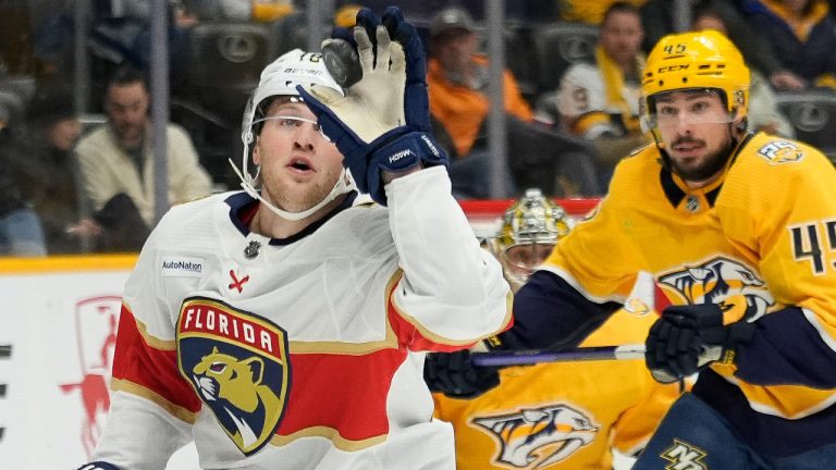 Florida Panthers centre Steven Lorentz, left, catches the puck past Nashville Predators defenseman Alexandre Carrier (45) during the first period of an NHL hockey game Monday, Jan. 22, 2024, in Nashville, Tenn. (George Walker IV/AP) 