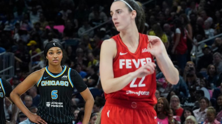 Chicago Sky forward Angel Reese, left, watches Indiana Fever guard Caitlin Clark take a free throw during the second half of a WNBA basketball game Friday, Aug. 30, 2024, in Chicago. (Erin Hooley/AP) 