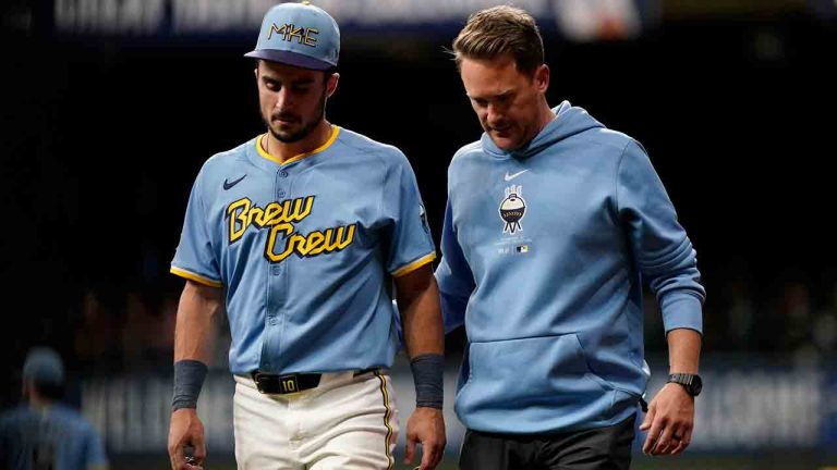 Milwaukee Brewers' Sal Frelick is helped off the field by a trainer after suffering an injury during the third inning of a baseball game against the New York Mets, Friday, Sept. 27, 2024, in Milwaukee. (Aaron Gash/AP)