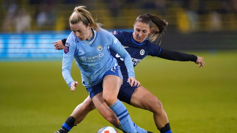 Manchester City's Lauren Hemp, left, and Chelsea's Eve Perisset battle for the ball during a Women's League Cup semifinal soccer match. (Bradley Collyer/PA via AP)