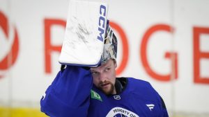 Vancouver Canucks goalie Thatcher Demko lifts his mask off his face while practicing with coaches during the opening day of the NHL hockey team's training camp, in Penticton, B.C., on Thursday, September 19, 2024. (Darryl Dyck/CP Photo)